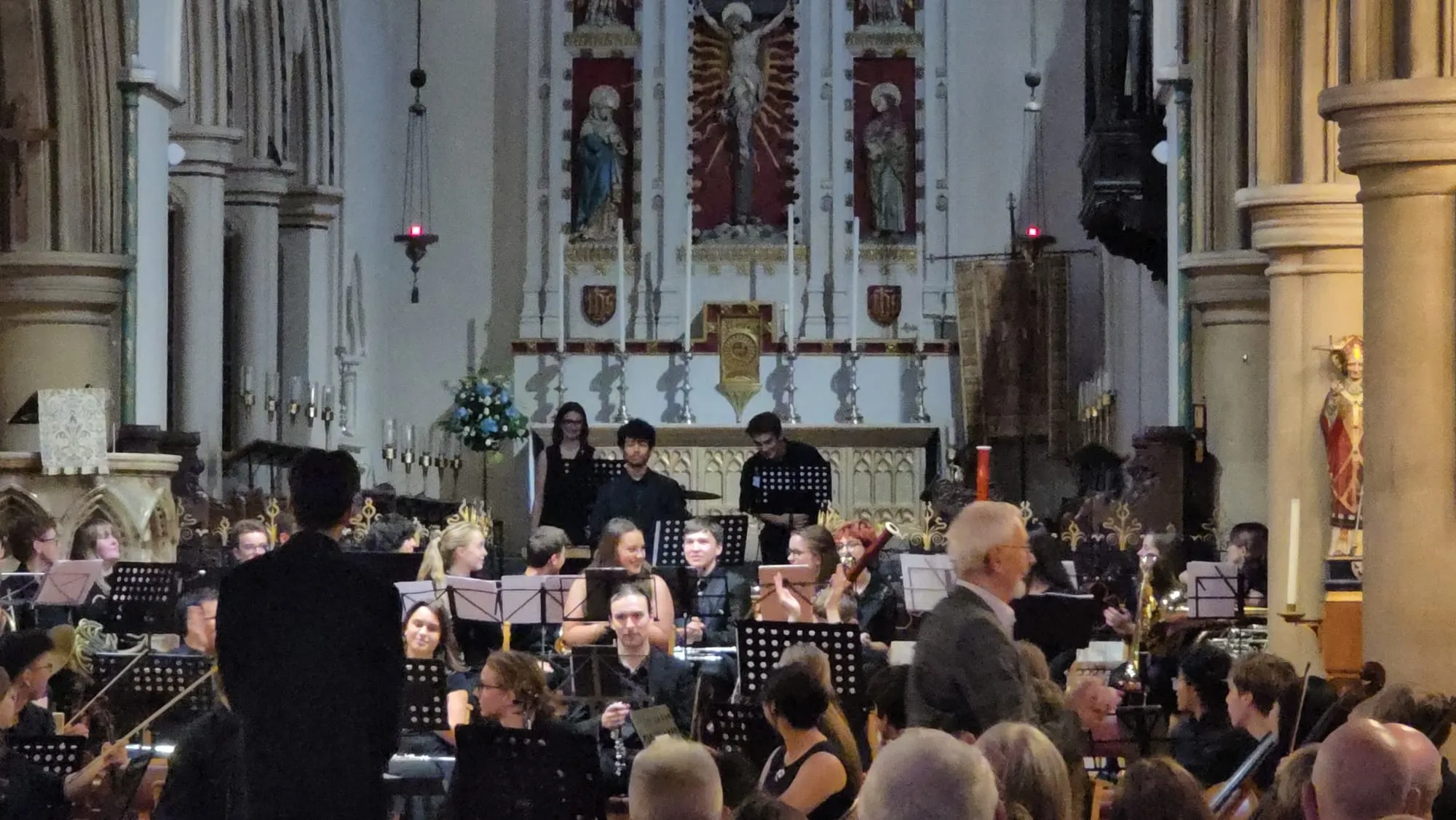 The orchestra takes a bow as the audience applauds.