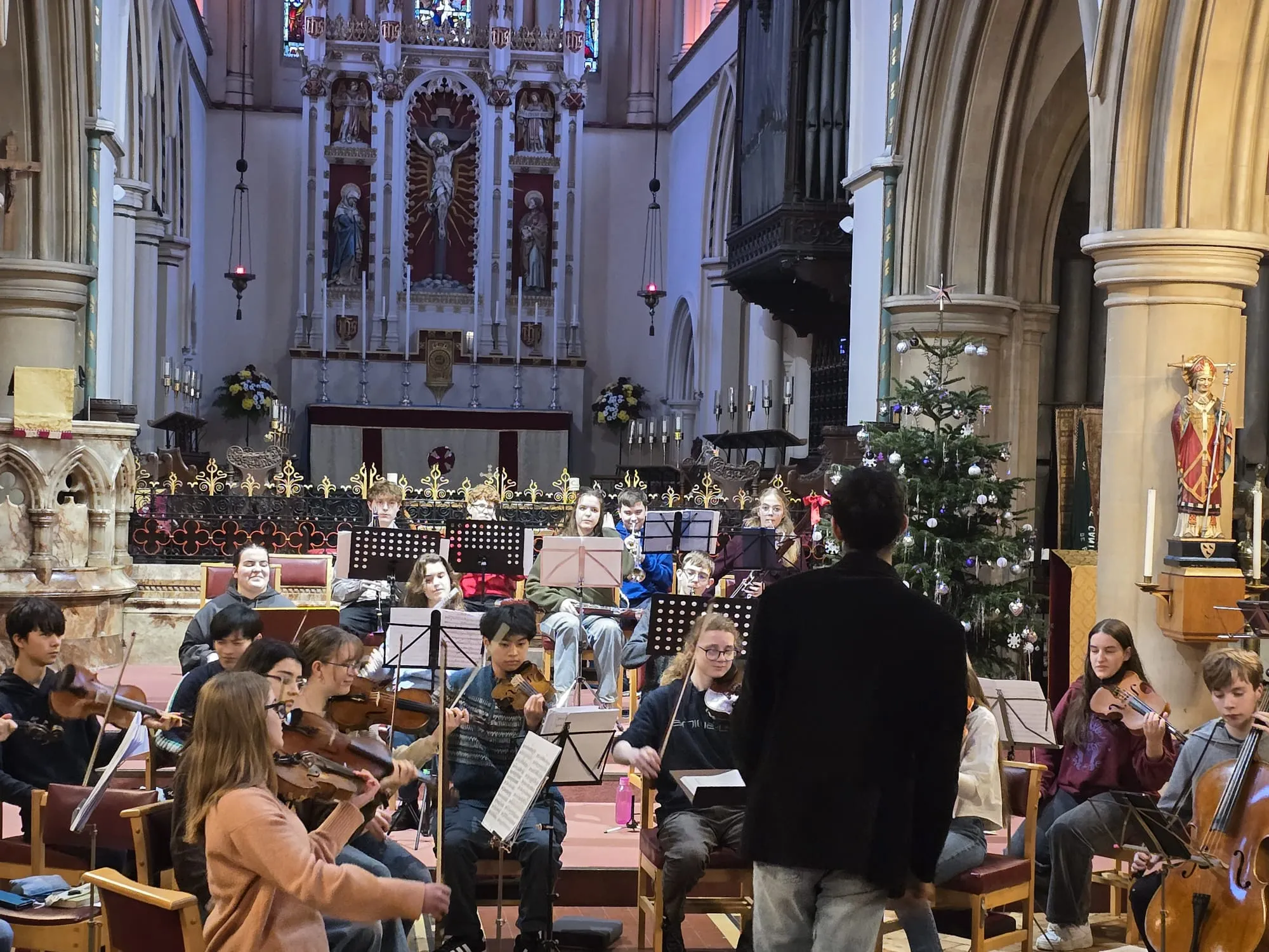 Golden afternoon light fills the nave during rehearsal.